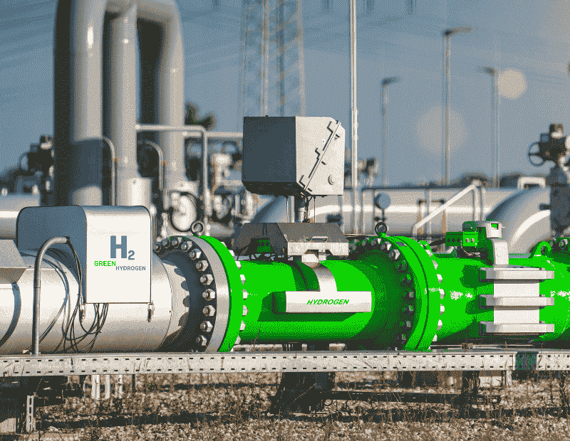 "Green hydrogen pipeline infrastructure with labeled hydrogen pipes and industrial equipment, illustrating sustainable energy technology."