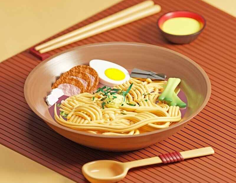 A bowl of ramen with noodles, sliced meat, boiled egg, green onions, and other toppings, served on a mat with chopsticks and a spoon.