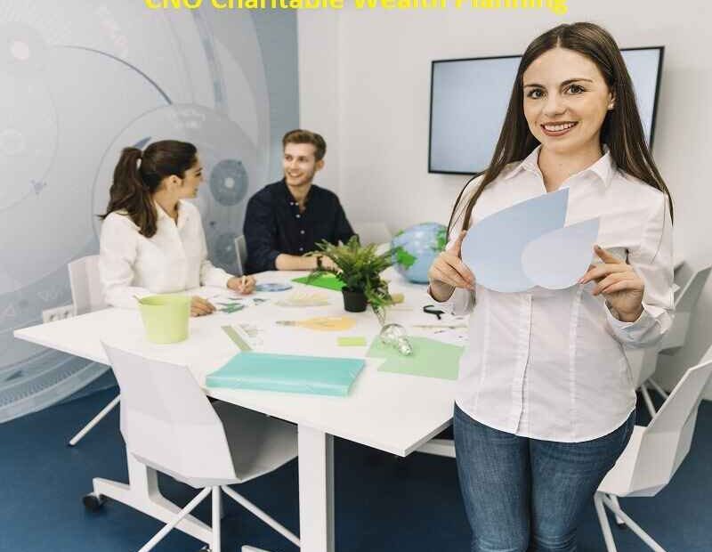 A young businesswoman smiling while holding a water drop icon, with two colleagues discussing strategies at a table in the background labeled "CNO Charitable Wealth Planning.